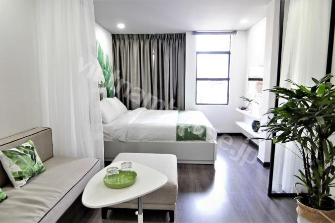 Two white beds within white serviced apartment 
